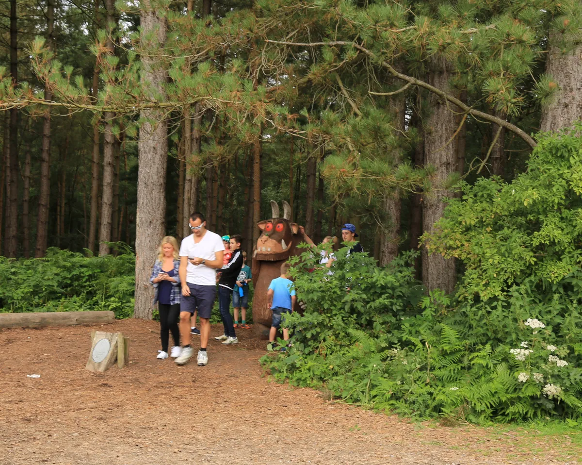 Family exploring a Gruffalo Trail in the woods