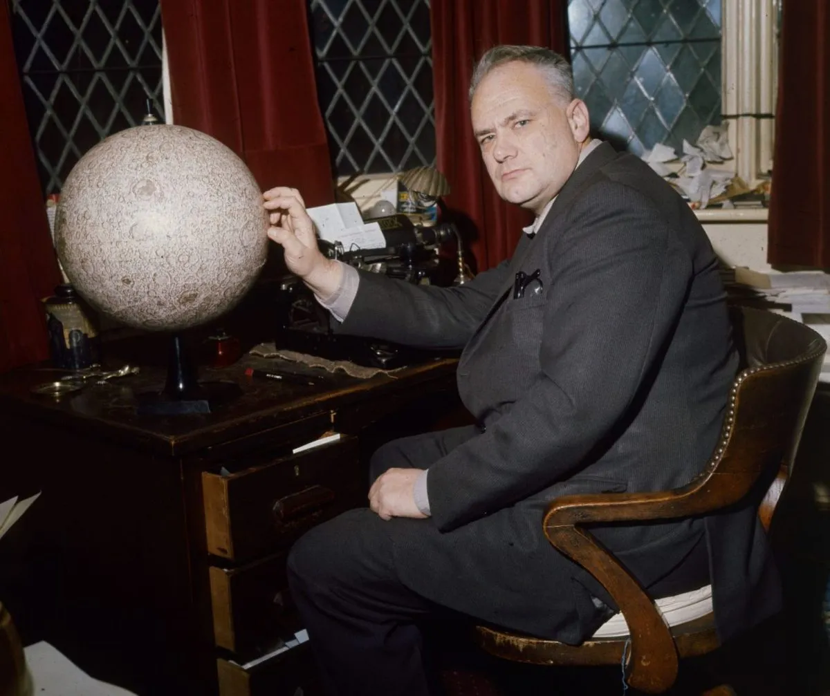 Patrick Moore pictured at his house in Selsey with a globe of the Moon. (Photo by Keystone/Getty Images)