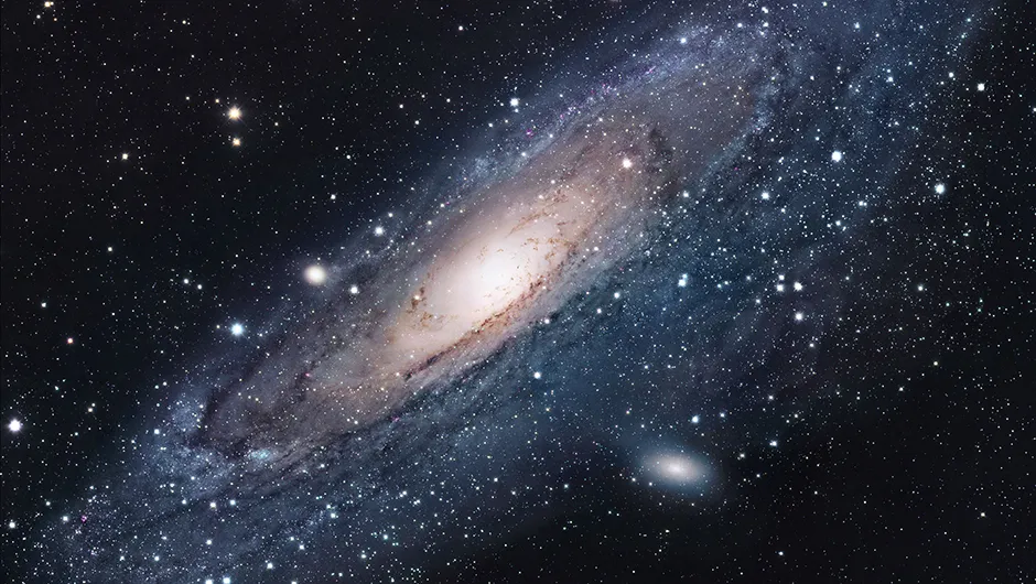 The Andromeda Galaxy, M31. Despite being our nearest galactic neighbour, its stars are only resolveable through a telescope, reminding us of the vastness of the Universe. Image credit: NASA/JPL-Caltech