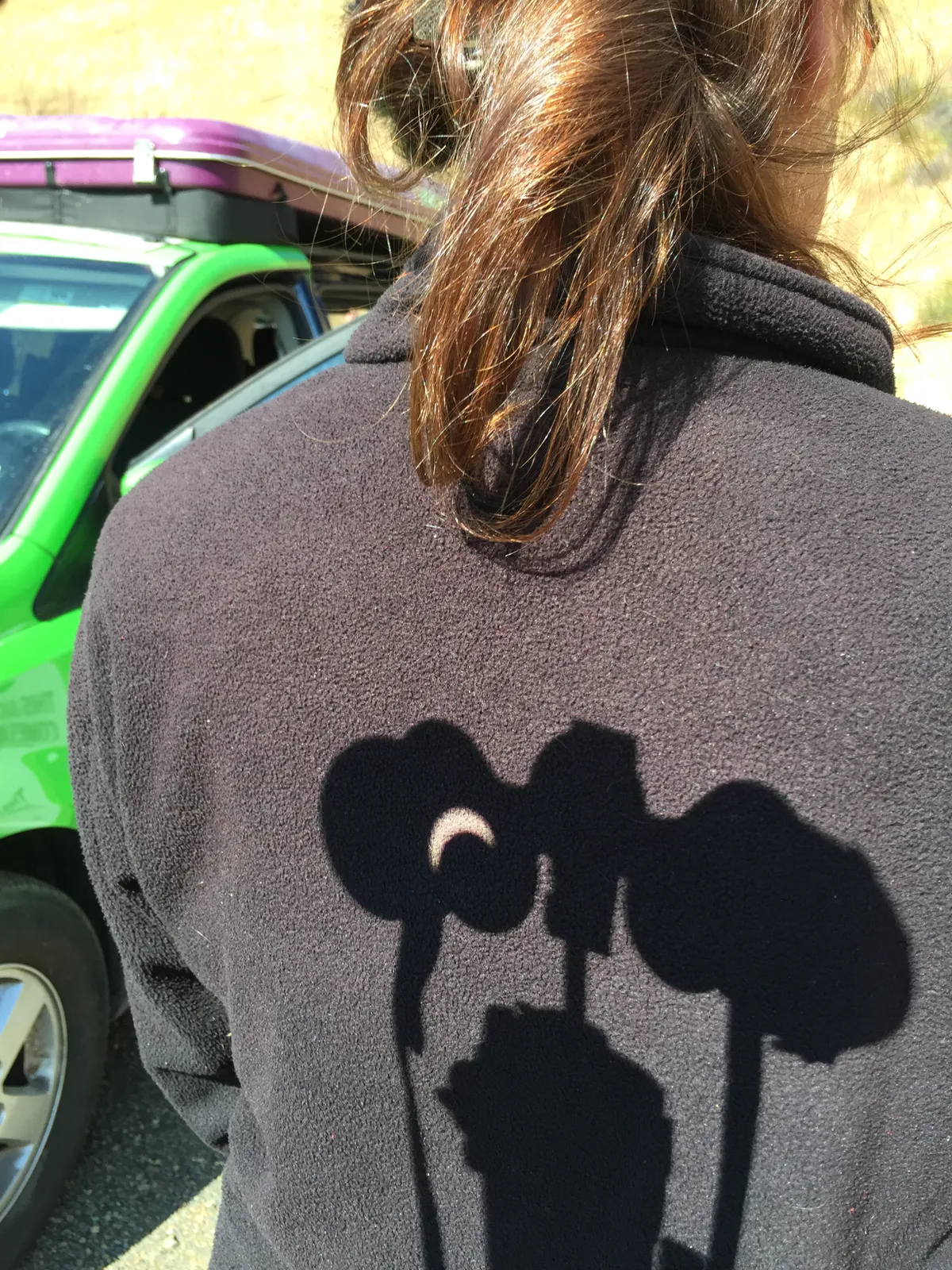 Talk about solar projection! A view of the eclipse projected through binoculars and onto a fellow eclipse chaser's back. Credit: Nick Spall.