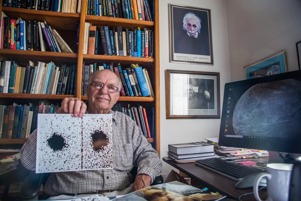 Christy pictured in 2018, holding two of the telescope images that enabled him to spot Pluto’s largest moon Charon. Credit: NASA/Johns Hopkins University Applied Physics Laboratory/Southwest Research Institute/Art Howard/GHSPi