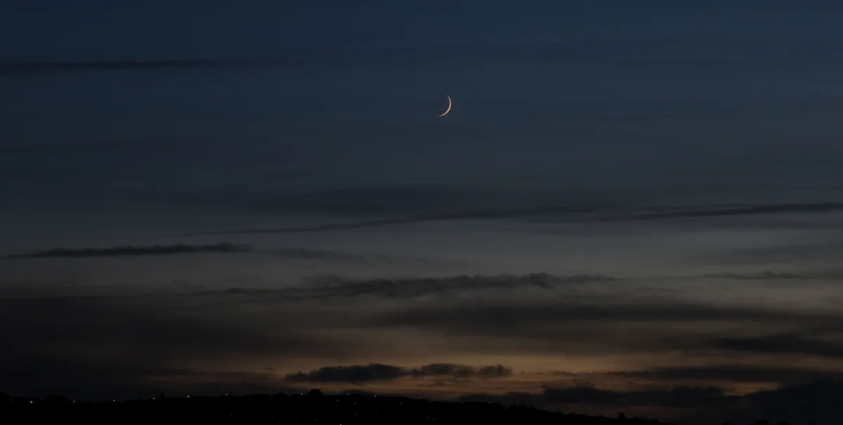 Waxing Crescent Moon over Gateshead by David Blanchflower, Newcastle upon Tyne. Equipment: Canon 1200D camera, Canon EF-S 75-300mm lens, tripod.