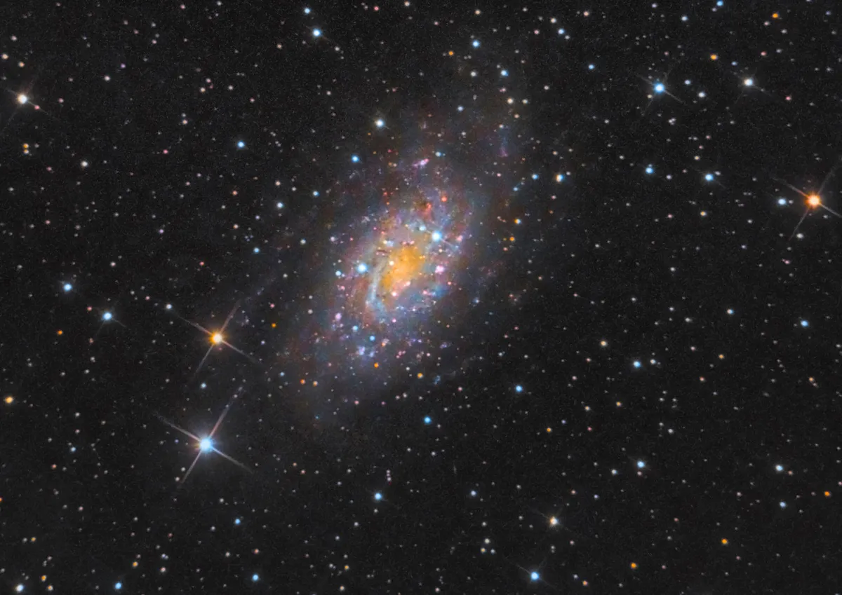 NGC2403 by David Slack, Prudhoe, Northumberland, UK. Equipment: Skywatcher 130p reflector, SXV-H9 CCD, EOS1100D DSLR, Baader 7nm Ha filter, Skywatcher HEQ5 pro mount and ZWO ASI120mm based finder guider.
