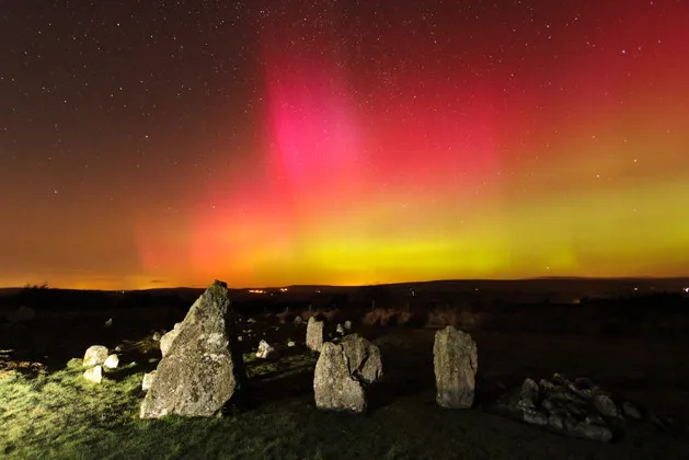 In Northern Ireland, Martin McKenna captured vivid naked-eye reds, greens and oranges with 80º high rays from the Beaghmore stone circle. Credit: Martin McKenna/Spaceweather.com