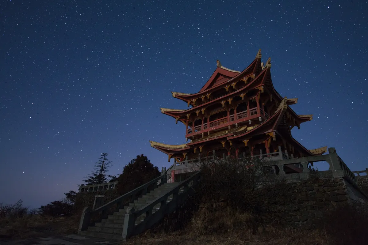 Stars above Ten Thousand Buddha by Jeff Dai, Mount Emei, Sichuan province of China. Equipment: Canon EOS 5D MarkII, AF-S Nikkor 14-24mm f/2.8G IF-ED.