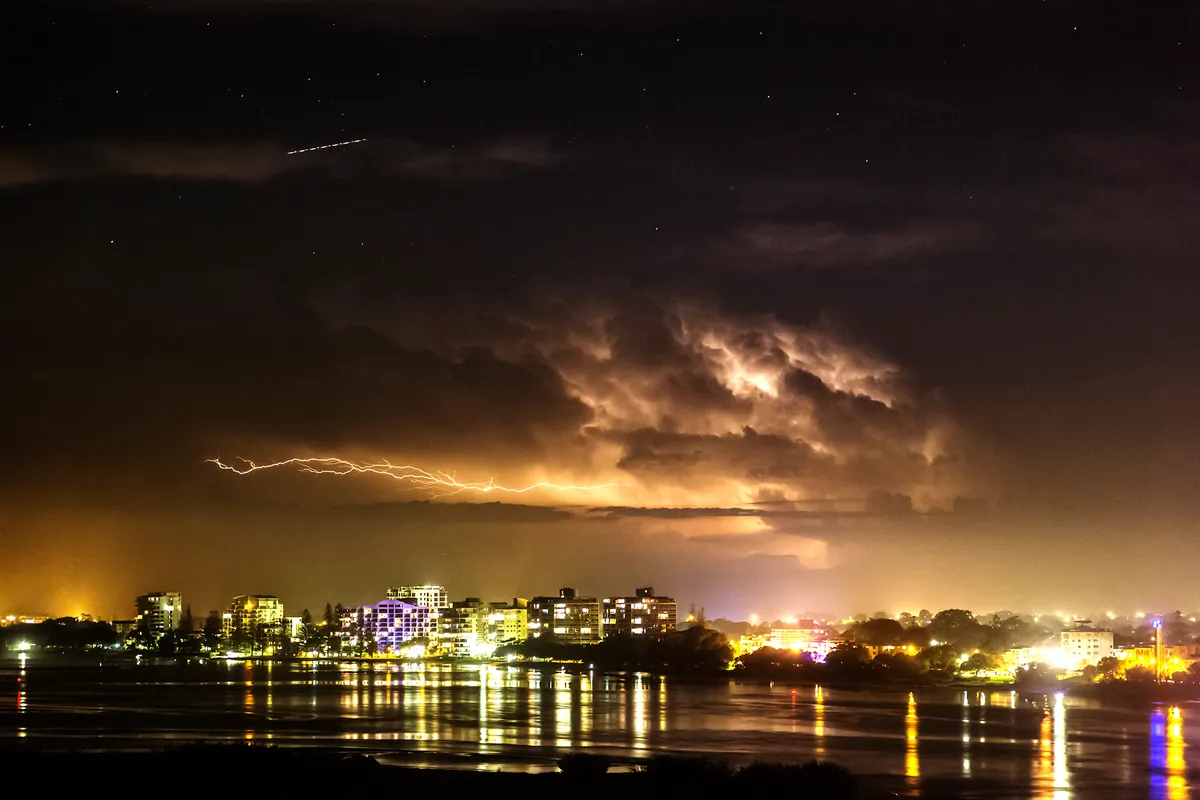 Stars poking through clouds, light pollution and lightning, photographed by John Short, Caloundra, Australia. Equipment: Canon 6D, EF28-105 L series lens.