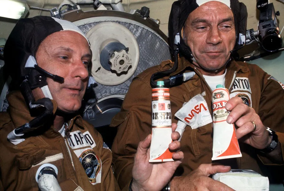 The 1975 Apollo-Soyuz Test Project saw US astronauts and Soviet cosmonauts dock their spacecraft together, in a symbolic show of cooperation at the height of the Cold War. Here, NASA astronauts Thomas P. Stafford (left) and Deke Slayton hold containers of borscht (beetroot soup), gifted by Soviet cosmonauts. Vodka labels were pasted on the tubes so that the astronauts could toast one another. Credit: NASA