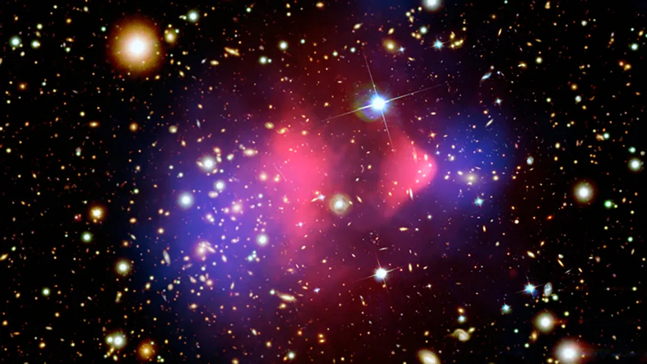 Galaxy cluster 1E 0657-56, known as the Bullet Cluster. Red represents the total visible mass and the blue hues show the distribution of dark matter in the cluster. Credit: NASA/CXC/CfA/M.Markevitch et al