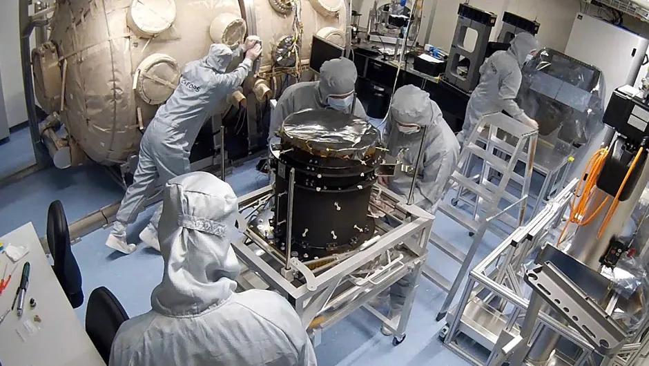 The CHEOPS team at the University of Bern assembles the instrument flight model in the cleanroom. ESA's CHEOPS will study already-known transiting exoplanets in greater detail. Credit: PlanetS