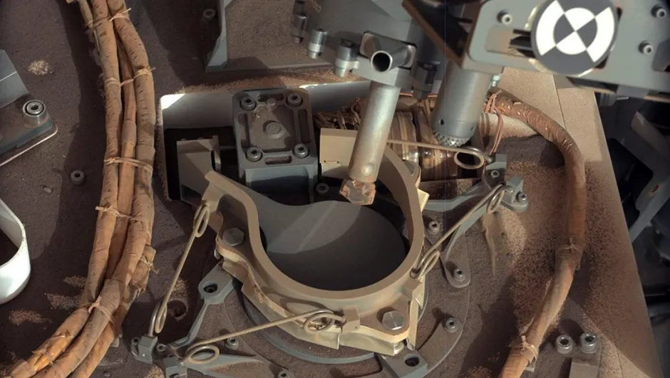 An image of the drill bit on the Curiosity rover, positioned over one of the sample inlets on the rover's deck. The inlets lead to Curiosity's onboard laboratories. Image credit: NASA/JPL-Caltech/MSSS