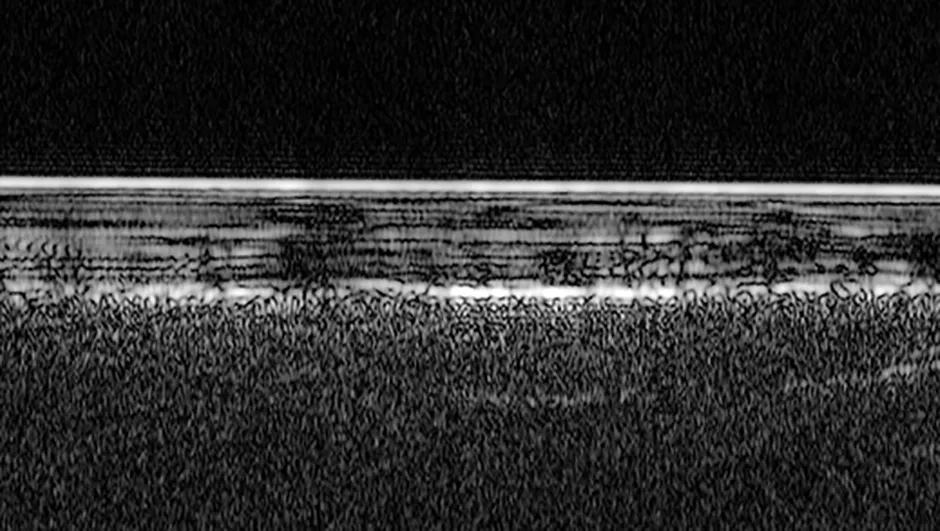 A radar profile of the south polar region of Mars. The bright feature at the top is the icy surface, and layers of ice and dust are seen extending about 1.5km deep. The brightest reflections from the base layer close to the centre of the image are interpreted as a pond of liquid water. Credit: ESA/NASA/JPL/ASI/Univ. Rome; R. Orosei et al 2018