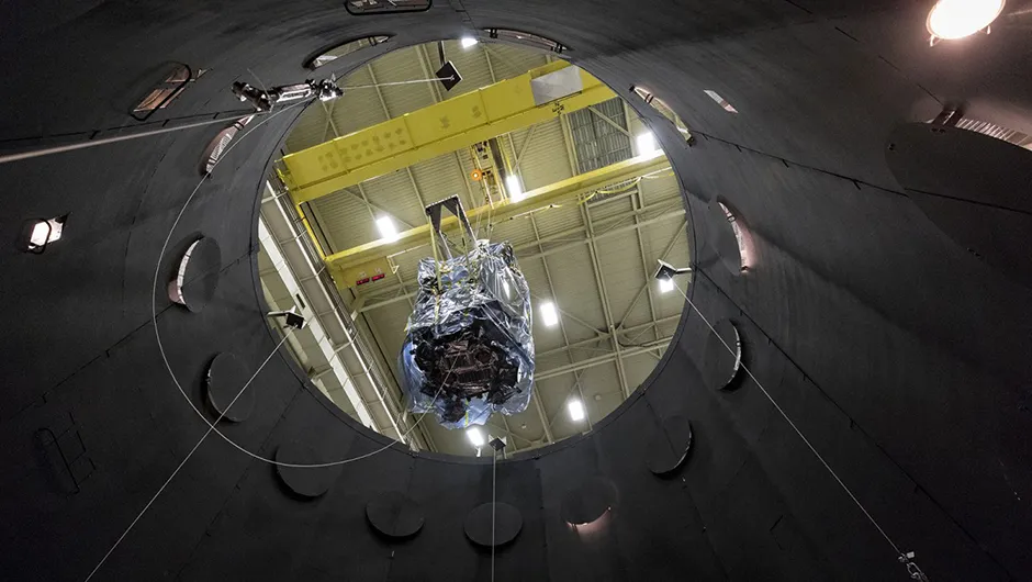 The Parker Solar Probe is lowered into the thermal vacuum chamber that simulates the harsh conditions the spacecraft will face on its journey through space. Credit: NASA/JHUAPL/Ed Whitman