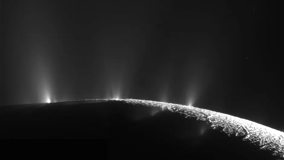 An image of Enceladus captured by Cassini, showing plumes of vapour bursting through Enceladus’s icy crust. Credit: NASA/JPL-Caltech/SSI