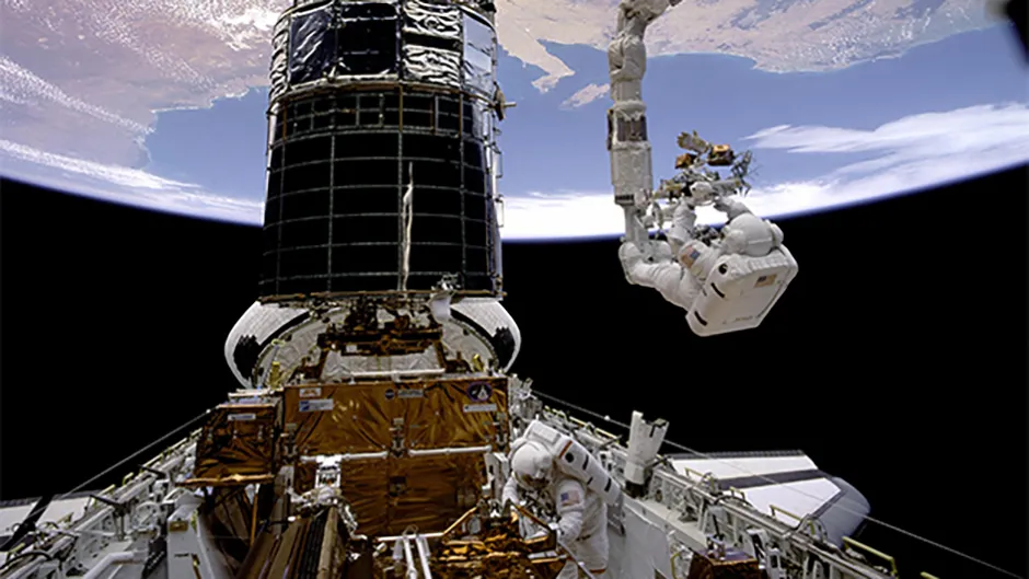 The first servicing mission to the Hubble Space Telescope. Astronauts installed lenses to correct the flawed main mirror in the telescope. Credit: NASA