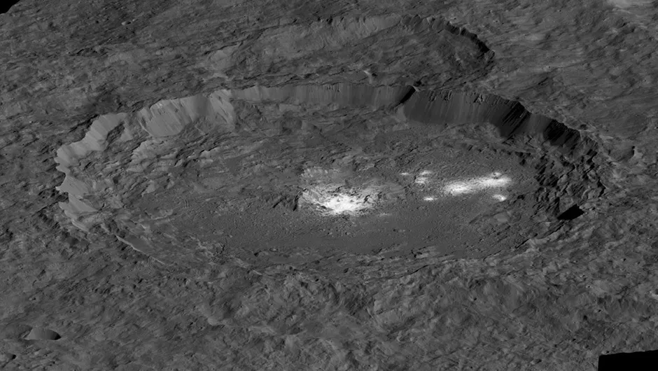A simulated view of the Occator Crater, created using data from the Dawn mission. Some of the mysterious bright spots can be seen within the crater. Credit: NASA/JPL-Caltech/UCLA/MPS/DLR/IDA