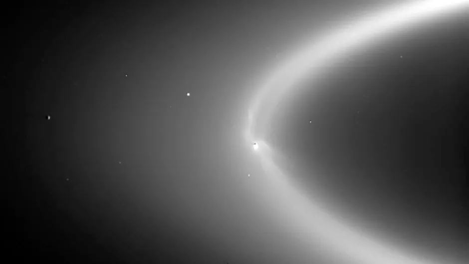 The plumes of Enceladus feed into Saturn's E-ring, a wide ring made up of tiny particles, rather than larger blocks of ice. Image Credit: NASA