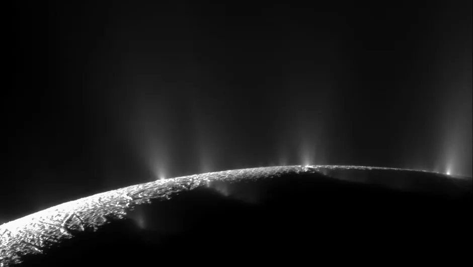 This image captured by the Cassini spacecraft shows plumes of water ice erupting from the surface of Enceladus. Do similar plumes exist on Jupiter’s moon Europa? Credit: NASA/JPL-Caltech/SSI