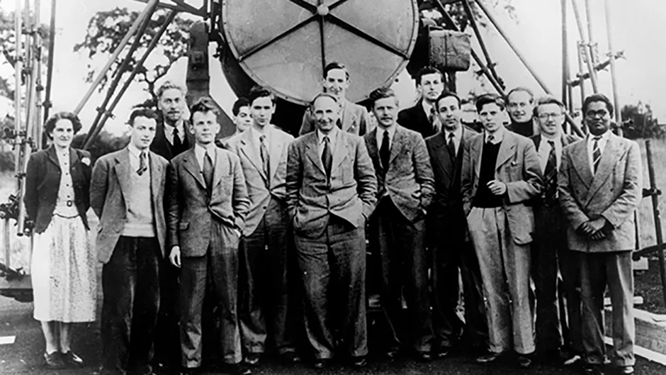 Sir Bernard Lovell (centre) and the Jodrell Bank Observatory team in front of the Searchlight Aerial in 1951 Credit: The University of Manchester