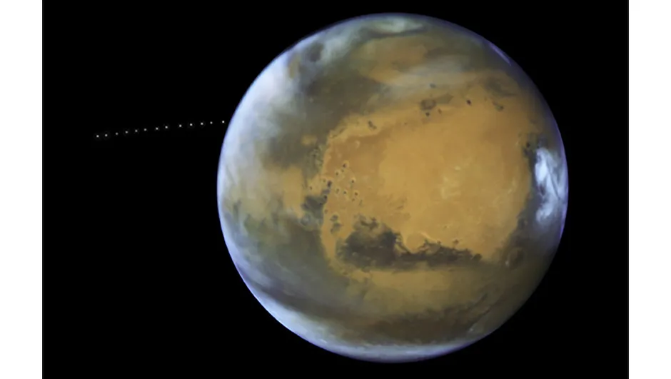 Phobos photobomb: this image of the moon Phobos orbiting Mars was captured by the Hubble Space Telescope on 12 May 2016.Phobos’s orbit takes it closer to Mars by 2 metres every one hundred years. Scientists estimate the moon will be torn apart by this process in about 30-50 million years. Copyright NASA, ESA and Z. Levay (STScI) Acknowledgment: J. Bell (ASU) and M. Wolff (Space Science Institute)