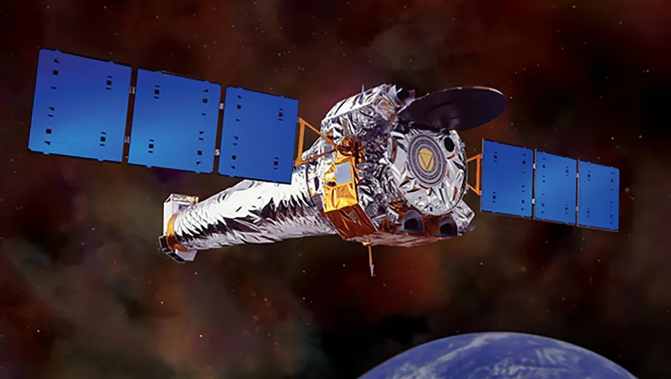 An artist's impression of the Chandra X-ray Observatory in orbit around Earth. X-ray enables astronomers to see things in the Universe that would be invisible in optical light. This NASA telescope was used to carry out follow-up observations that revealed the hidden galaxy clusters. Credit: NASA