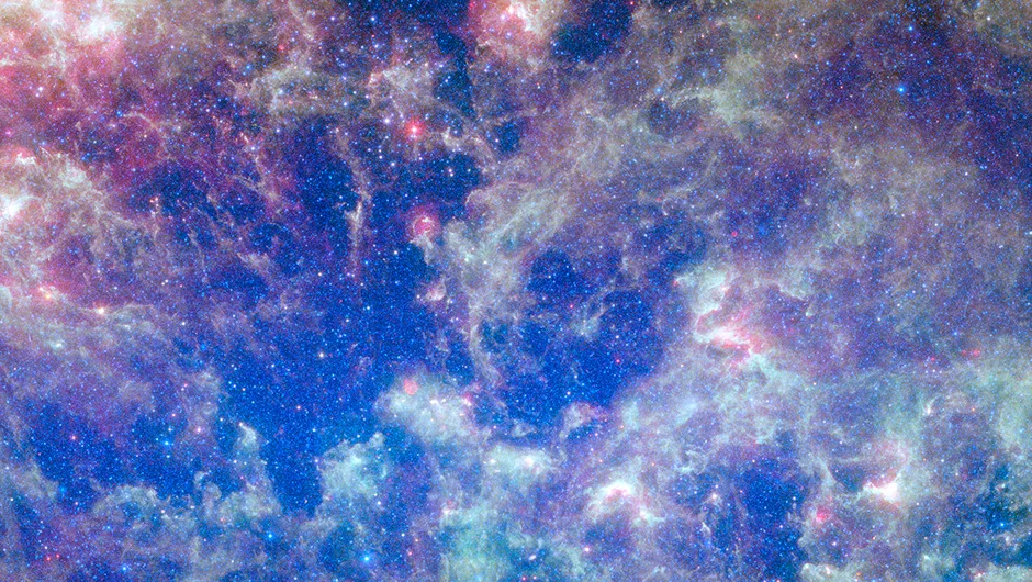 This vibrant image from NASA's Spitzer Space Telescope shows the Large Magellanic Cloud, a satellite galaxy to our own Milky Way galaxy.The infrared image, a mosaic of 300,000 individual tiles, offers astronomers a unique chance to study the lifecycle of stars and dust in a single galaxy. Nearly one million objects are revealed for the first time in this Spitzer view, which represents about a 1,000-fold improvement in sensitivity over previous space-based missions. Most of the new objects are dusty stars of various ages populating the Large Magellanic Cloud; the rest are thought to be background galaxies. The blue color in the picture, seen most prominently in the central bar, represents starlight from older stars. The chaotic, bright regions outside this bar are filled with hot, massive stars buried in thick blankets of dust. The red color around these bright regions is from dust heated by stars, while the red dots scattered throughout the picture are either dusty, old stars or more distant galaxies. The greenish clouds contain cooler interstellar gas and molecular-sized dust grains illuminated by ambient starlight. Astronomers say this image allows them to quantify the process by which space dust the same stuff that makes up planets and even people is recycled in a galaxy. The picture shows dust at its three main cosmic hangouts: around the young stars, where it is being consumed (red-tinted, bright clouds); scattered about in the space between stars (greenish clouds); and in expelled shells of material from old stars (randomly-spaced red dots). The Large Magellanic Cloud, located 160,000 light-years from Earth, is one of a handful of dwarf galaxies that orbit our own Milky Way. It is approximately one-third as wide as the Milky Way, and, if it could be seen in its entirety, would cover the same amount of sky as a grid of about 480 full moons. About one-third of the entire galaxy can be seen in the Spitzer image. This picture is a composite of infrared li