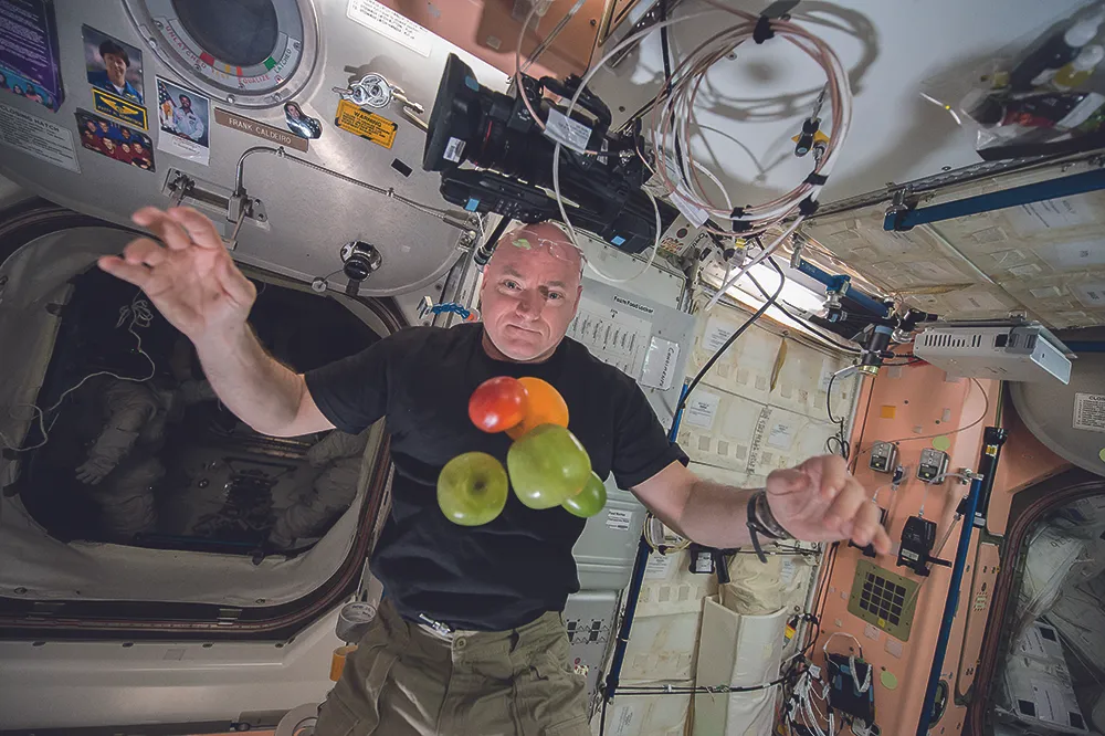 Scott Kelly pictured on board the ISS with a fresh delivery of fruit. Credit: NASA