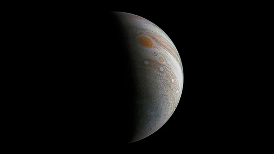 Roman Tkachenko processed this image of crescent Jupiter and its Great Red Spot using raw data captured by the Juno spacecraft. Credit: NASA/JPL-Caltech/SwRI/MSSS/Roman Tkachenko