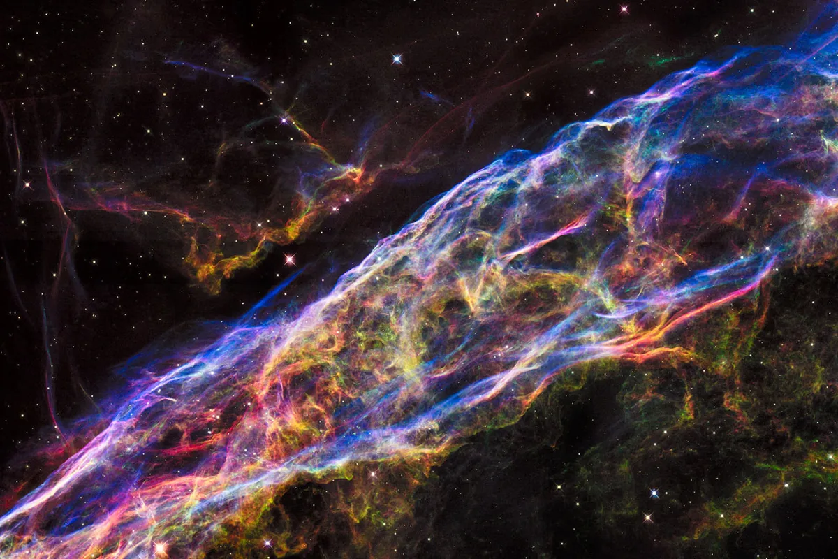 This image shows a small section of the Veil Nebula, as it was observed by the NASA/ESA Hubble Space Telescope. This section of the outer shell of the famous supernova remnant is in a region known as NGC 6960 or — more colloquially — the Witch’s Broom Nebula.
