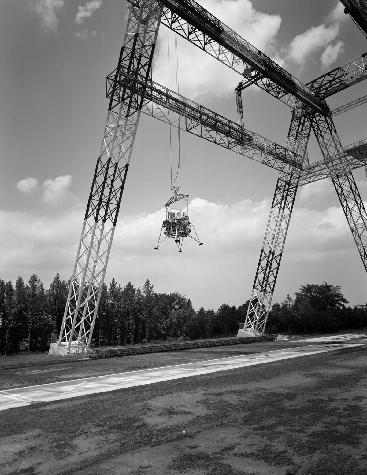 Lunar landing testing,18 June 1965. Here, NASA test the landing procedures of a lunar module. The 75m high and 122m long gantry structure became active in 1965 and was used extensively during the Apollo programme.Credit: NASA