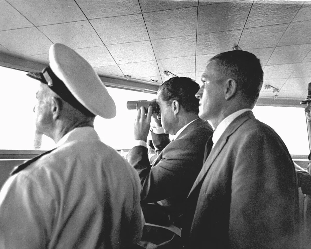 Mission recovery,July 24, 1969. US President Richard Milhous Nixon (centre) watches the recovery of the Apollo 11 Lunar Mission, aboard the USS Hornet aircraft carrier. Standing next behind Nixon (right of the image) is astronaut Frank Borman, Apollo 8 Commander. Credit: NASA