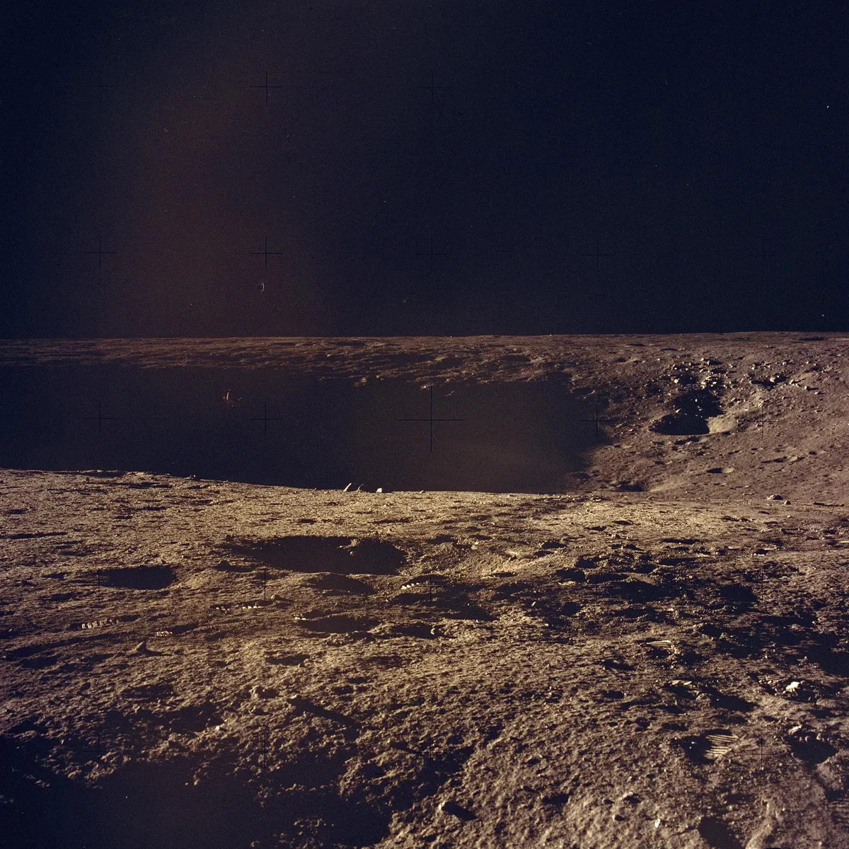 Lunar surface exploration,14 - 24 November. Apollo 12 was designed to carry out a number of lunar soil activities including the collection of 34kg of rock samples. This image was taken during the mission, showing the lunar surface and the footprints of the astronauts in the dust.Credit: NASA