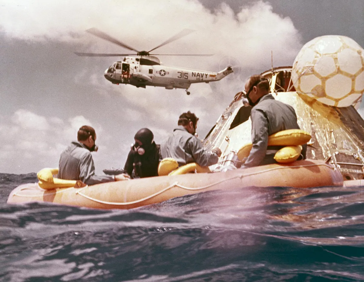 Pacific recovery,24 November 1969. The recovery of the Apollo 12 mission, the second manned mission to the Moon. Apollo 12 astronauts were Lunar Module pilot Alan L Bean, Command Module pilot Richard Gordon and Commander Charles Conrad. All three can be seen in the life raft.Credit: NASA