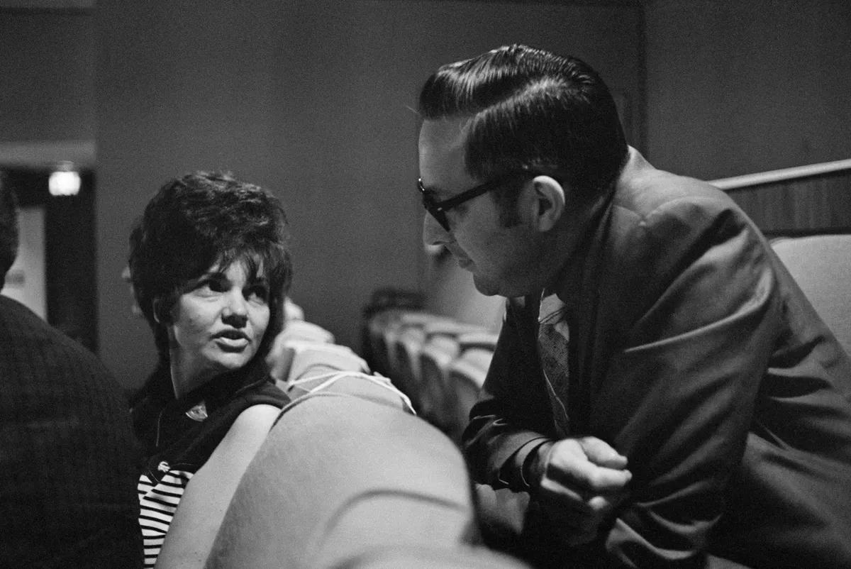 Special viewing,14 April 1970. Marilyn Lovell, wife of Apollo 13 astronaut James A Lovell chats with Dr Charles A Berry, Apollo 13 flight surgeon. Shortly after this image was taken, an explosion in the Service Module caused the cancellation of the lunar landing phase of the mission.Credit: NASA