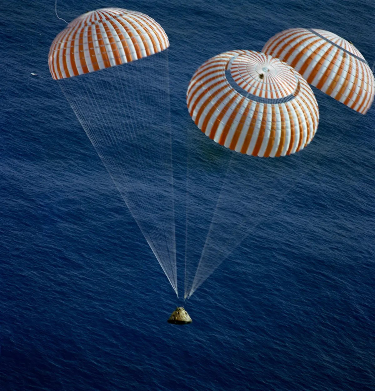 The final descent,19 December 1972. The Apollo 17 Command Module, with astronauts Eugene A Cernan, Ronald E Evans and Harrison H Schmitt aboard, nears splashdown in the south Pacific Ocean, successfully drawing the Apollo programme to a close.Credit: NASA
