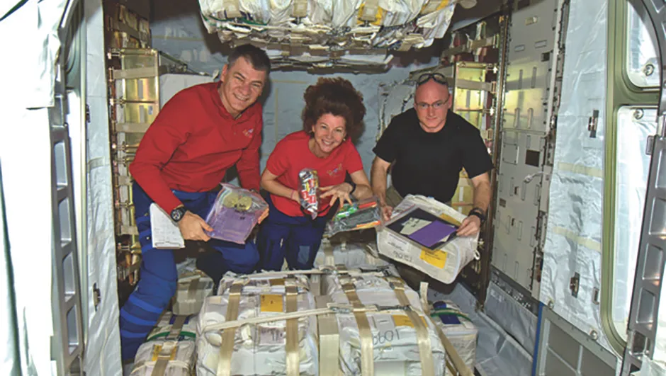 Expedition 26 open their care packages from Earth.Credit: NASA