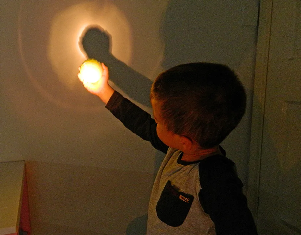 Teach kids about an eclipse with a tennis ball and torch. Credit: Steve Marsh