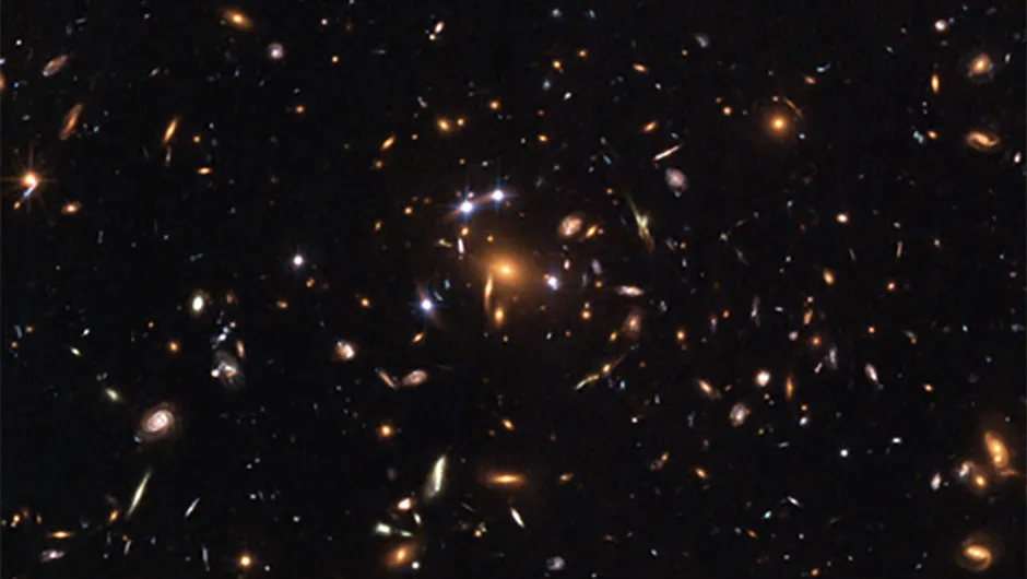 Credit: NASA, ESA, K. Sharon (Tel Aviv University) and E. Ofek (Caltech)This Hubble image shows gravitational lensing in action as the light from a distant quasar is bent and multiplied by the gravity of a cluster of galaxies in front of it.