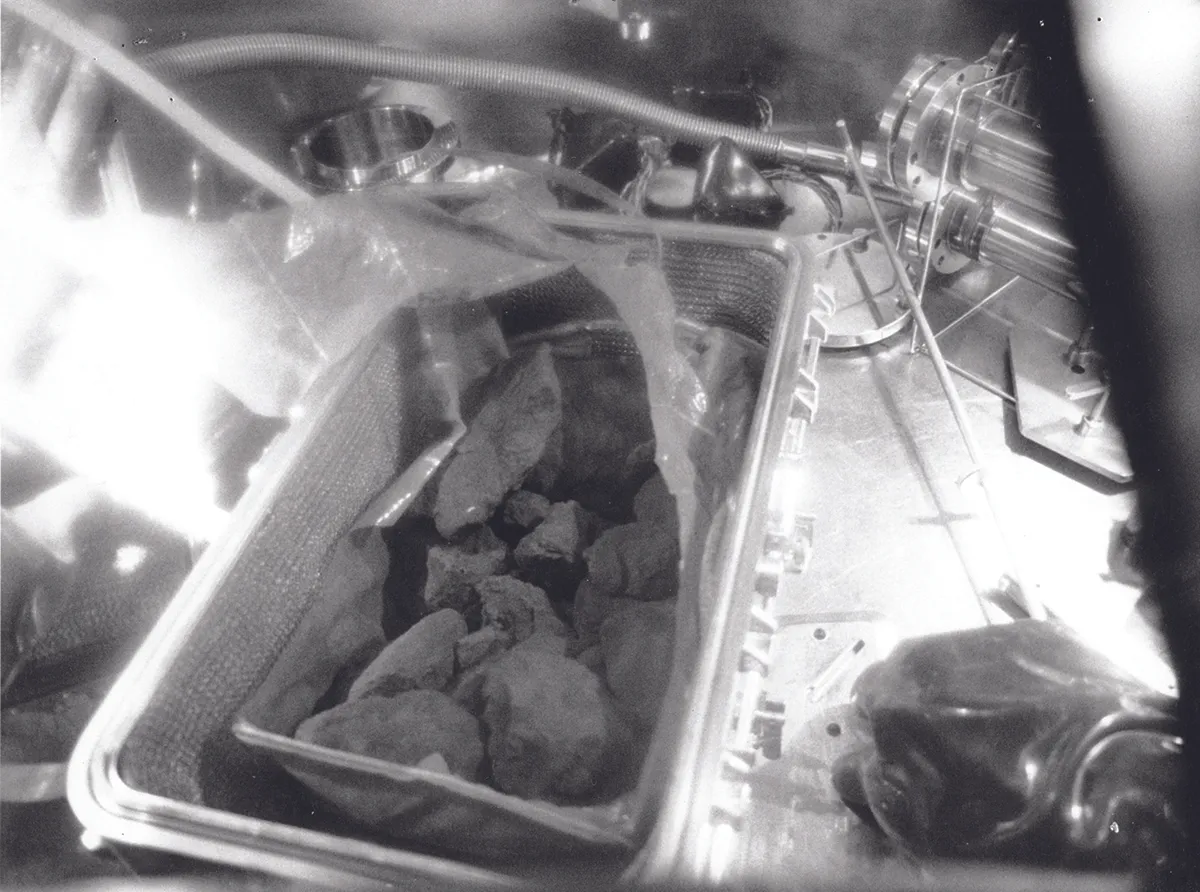 5.5kg of rocks from the lunar surface are carefully unloaded from their storage box for analysis in a vacuum chamber at the Lunar Receiving Laboratory, Houston. Credit: NASA