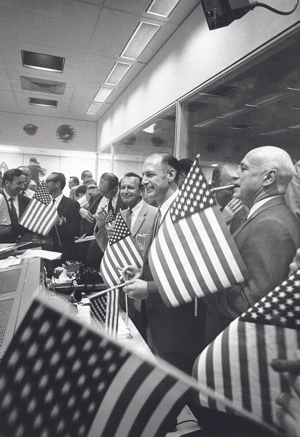 24 July 1969. On hearing the news of a safe splashdown celebratory cigars are lit at mission control in Houston. Credit: NASA