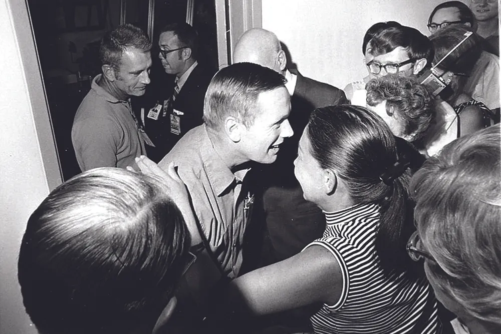 10 August 1969. Finally released from quarantine in the Lunar Receiving Laboratory, Houston, Armstrong is greeted by friends in the crew reception area. Credit: NASA