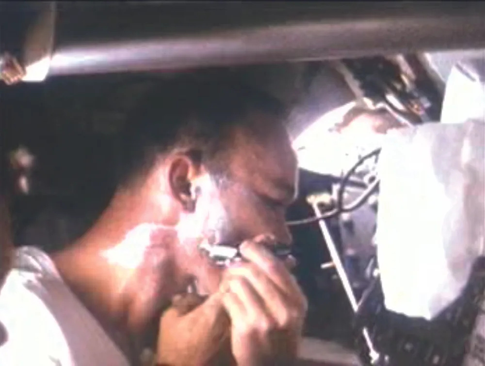 Michael Collins has a shave after nearly eight days in space. Credit: NASA