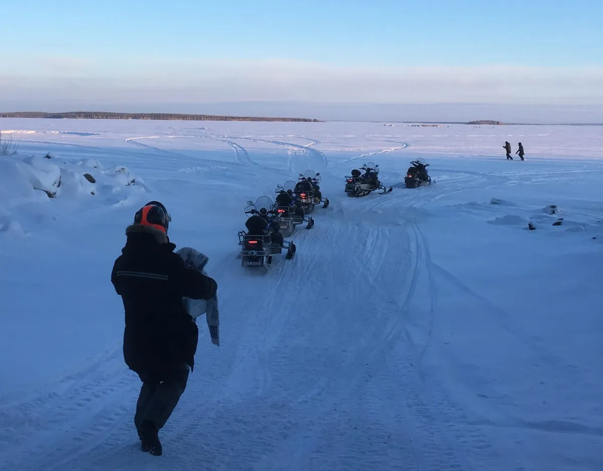 Joining a guided snowmobile tour over the frozen sea. Credit: Chris Bramley
