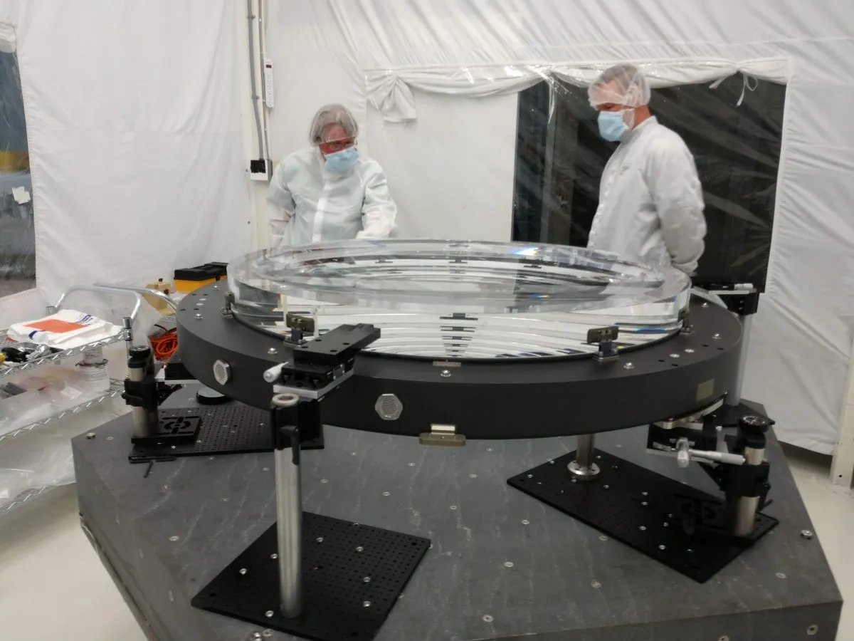 In June 2018 the L2 lens for the LSST Camera was attached to the pads that will mount to the composite ring of the L1-L2 assembly. Credit: LSST Camera Project