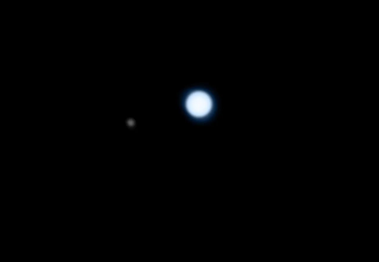 Neptune and its largest moon Triton imaged through a 356mm telescope. Credit: Pete Lawrence