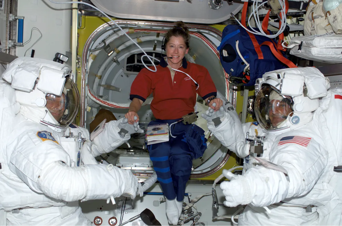 STS-112 pilot Pamela A. Melroy (centre) with Piers J. Sellers (left) and David A. Wolf, preparing for the first spacewalk of the mission, October 2002, which saw Melroy become the second woman to command a Space Shuttle. Credit: NASA.