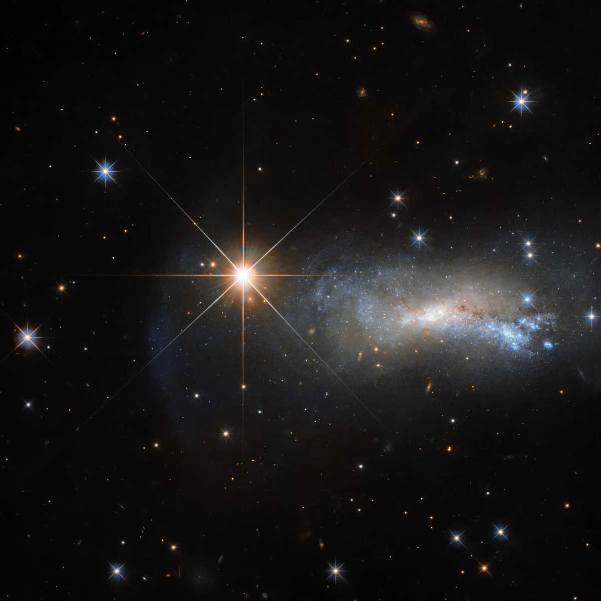 A Hubble Space Telescope image showing a galaxy NGC 7250. The bright object in the foreground is star TYC 3203-450-1.