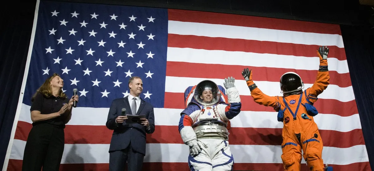 Spacesuit engineer Amy Ross (left) and NASA Administrator Jim Bridenstine (second from left) watch spacesuit engineer Kristine Davis wearing a prototype of NASA’s Exploration Extravehicular Mobility Unit (xEMU), 15 October 2019 at NASA headquarters in Washington. Dustin Gohmert (right), Orion Crew Survival Systems Project Manager, sports the Orion Crew Survival System suit, Credit: (NASA/Joel Kowsky).