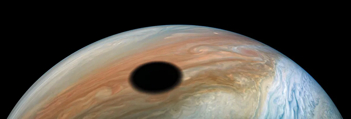 The shadow of moon Io projected onto Jupiter. Image credit: Image data: NASA/JPL-Caltech/SwRI/MSSS Image processing by Kevin M. Gill, CC BY 3.0