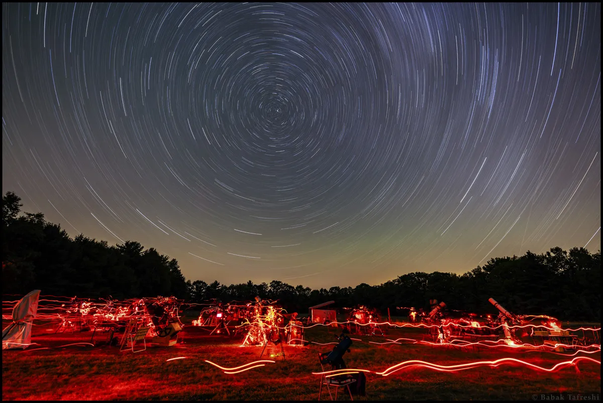 Long exposure image of star trails above stargazers using red flashlight, with Polaris near the center. Credit: Keeping your equipment compact and lightweight will help you travel to remote locations for that perfect shot. Credit: Babak Tafreshi, TWAN