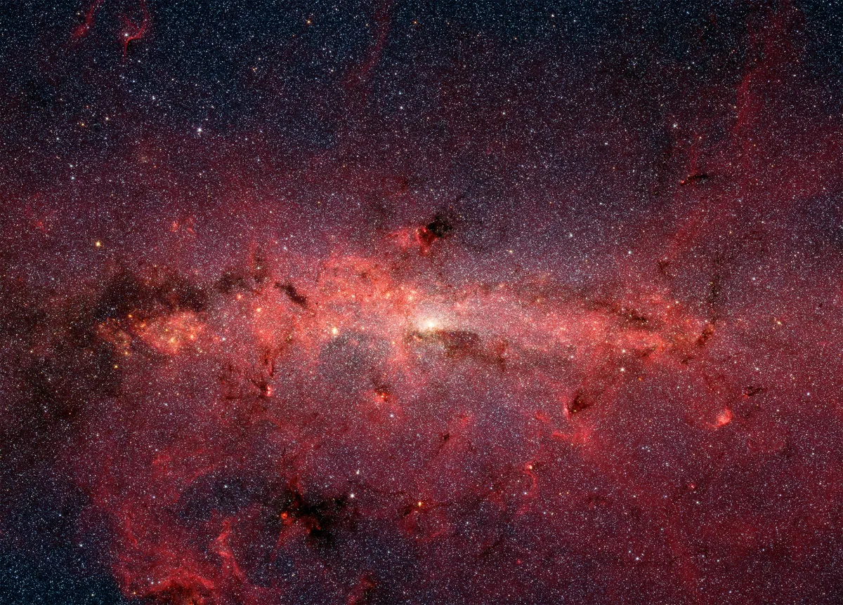 The heart of the Milky Way Throngs of ancient stars and luminous clouds of dust lit up by young stars characterise our Milky Way’s heart. Credit: NASA/JPL-Caltech/S. Stolovy (Spitzer Science Center/Caltech)